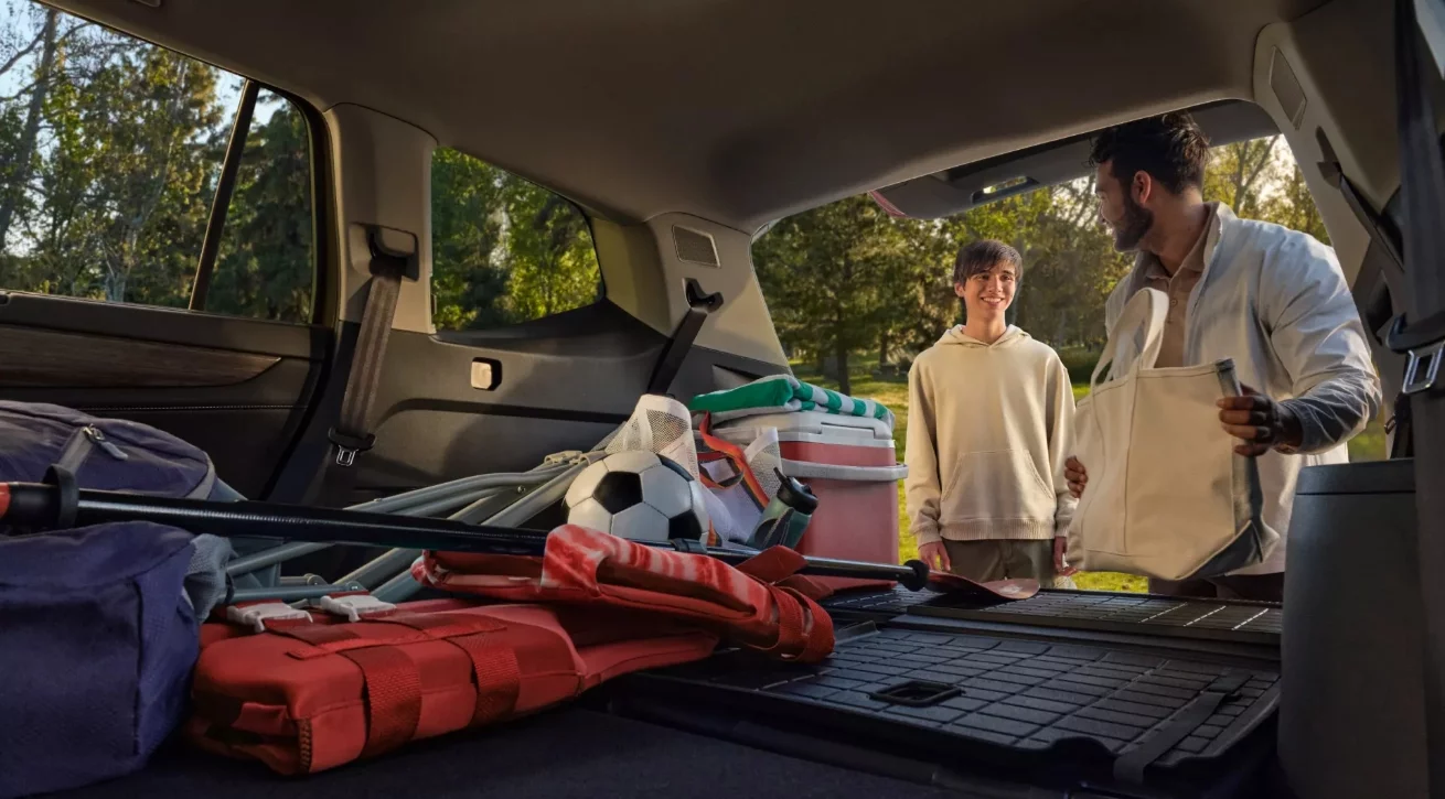 Family loading gear into the cargo area of a Volkswagen Atlas