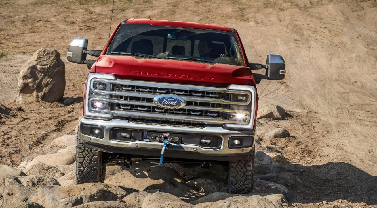 Red Ford Super Duty climbing a rocky off-road trail