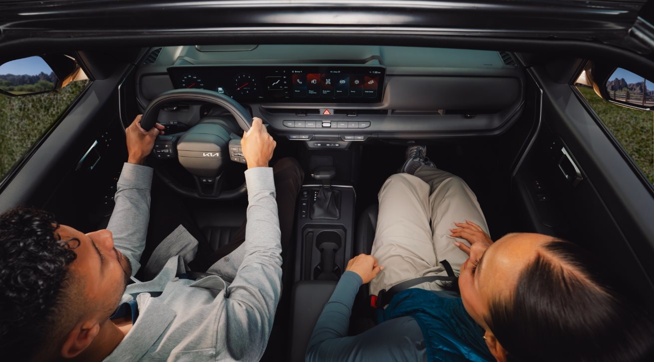 Driver and passenger inside the cabin of a Kia Seltos